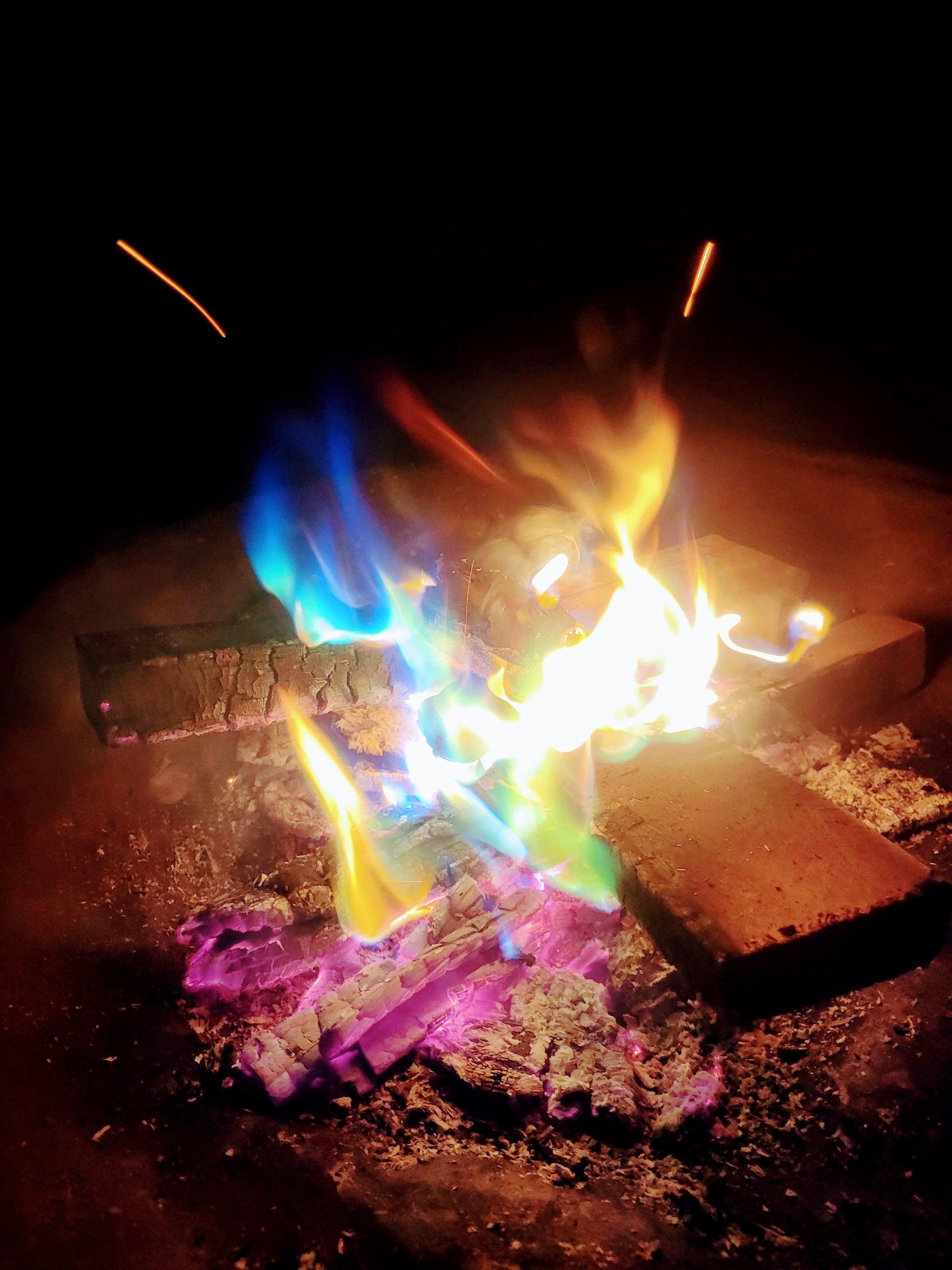 Nighttime campfire demonstration using Aurora Inferno for a magical-campfire-color-changing experience.